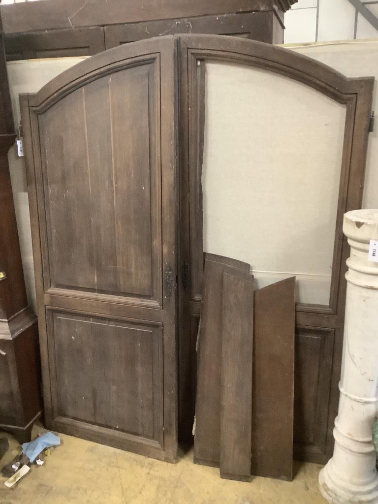 A pair of 18th century French oak armoire doors, width 150cm